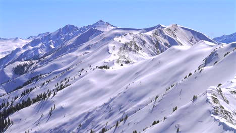 deep powder snow winter panorama aspen highlands bowl ski resort backcountry high alpine steep terrain colorado castle conundrum peak maroon bells wilderness elk mountain range blue sky sunny static