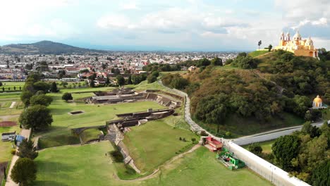 Thanks-to-the-brush-and-grasses-that-had-overgrown-its-walls,-the-largest-man-made-pyramid-in-the-world-has-been-mistaken-for-a-hill