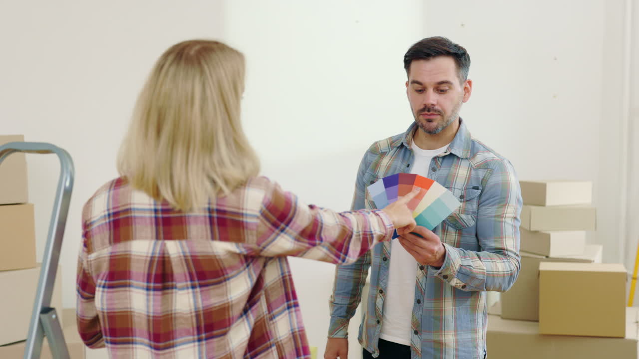 Couple Choosing Paint Color in a New Home