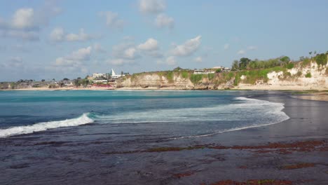 the surf spot of bingin at the cliffs of uluwatu during a sunny day