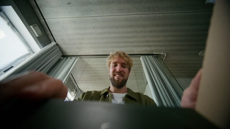 Man inspecting a device in a room