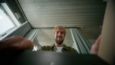 man inspecting a device in a room