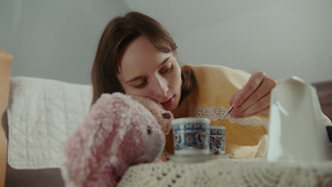 a girl playing with dolls in her room