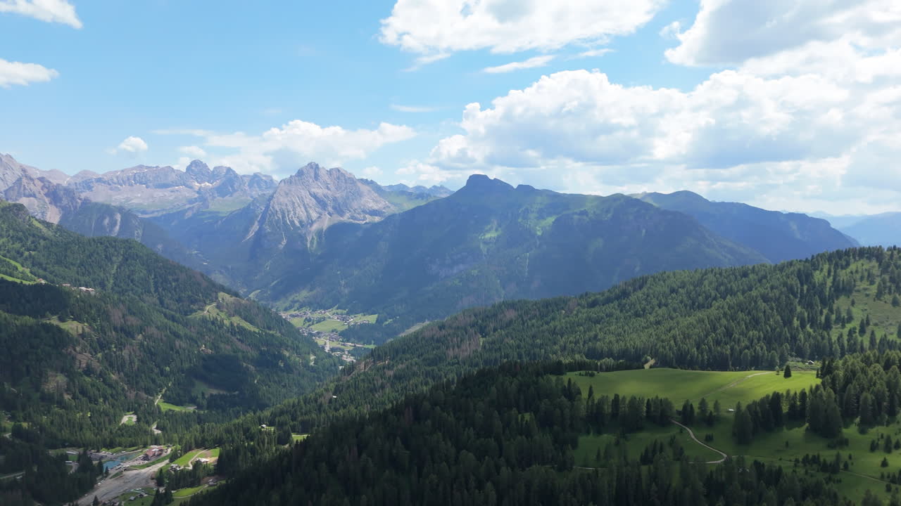 Luftaufnahme einer Alpental mit Wäldern und Wolken im Sommer. Malerische Berglandschaft in den italienischen Alpen