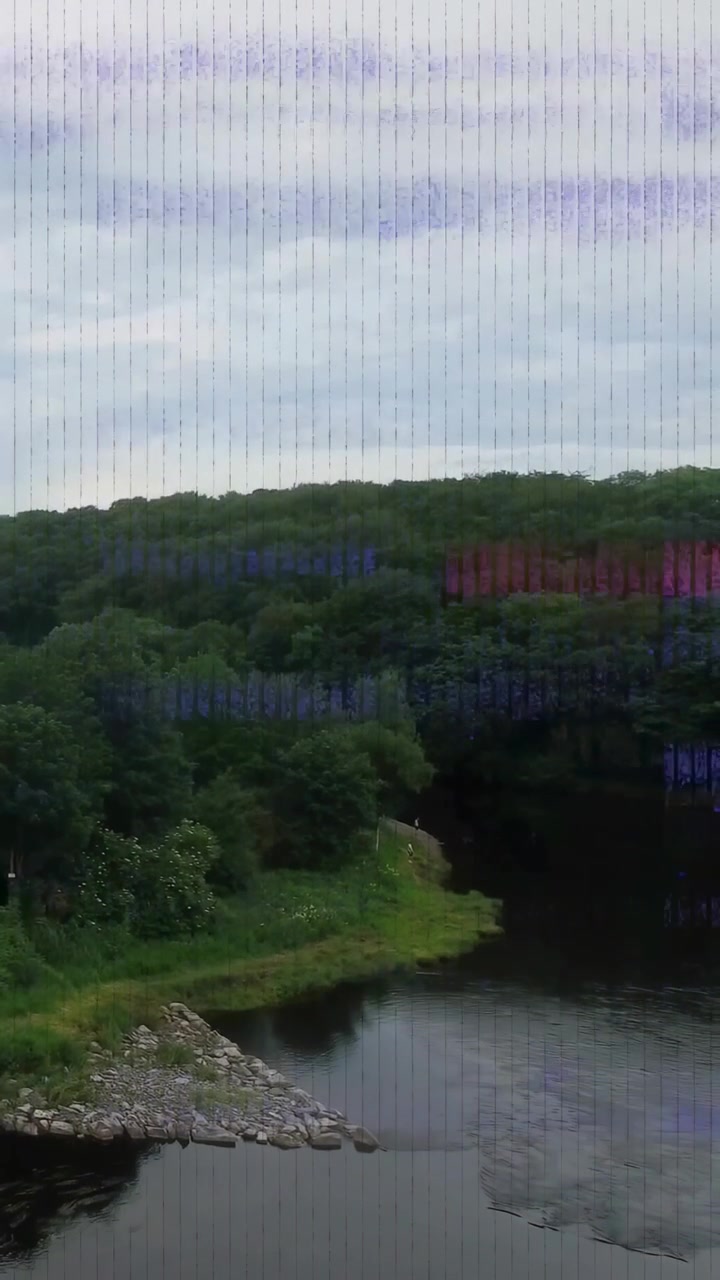 Vertical video: Artifact onset causing river bend rippling and purple banding, showing calm scene