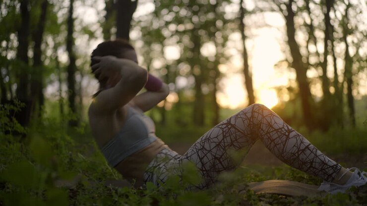 A woman exercising in a forest