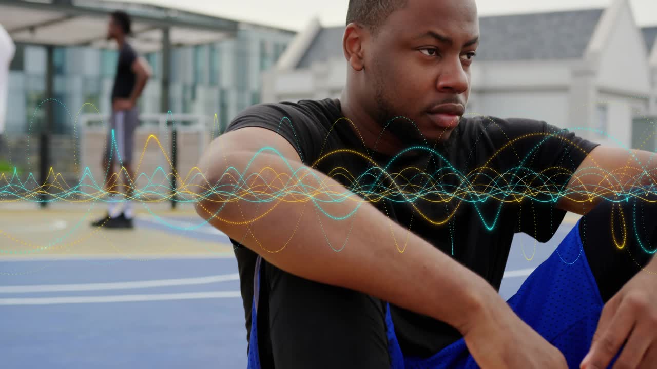 Panning upward showing male athlete on rooftop court holding ball with waveforms visualizing data