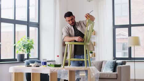 furniture-restoration,-diy-and-home-improvement-concept--man-with-ruler-measuring-old-wooden-chair-for-renovation