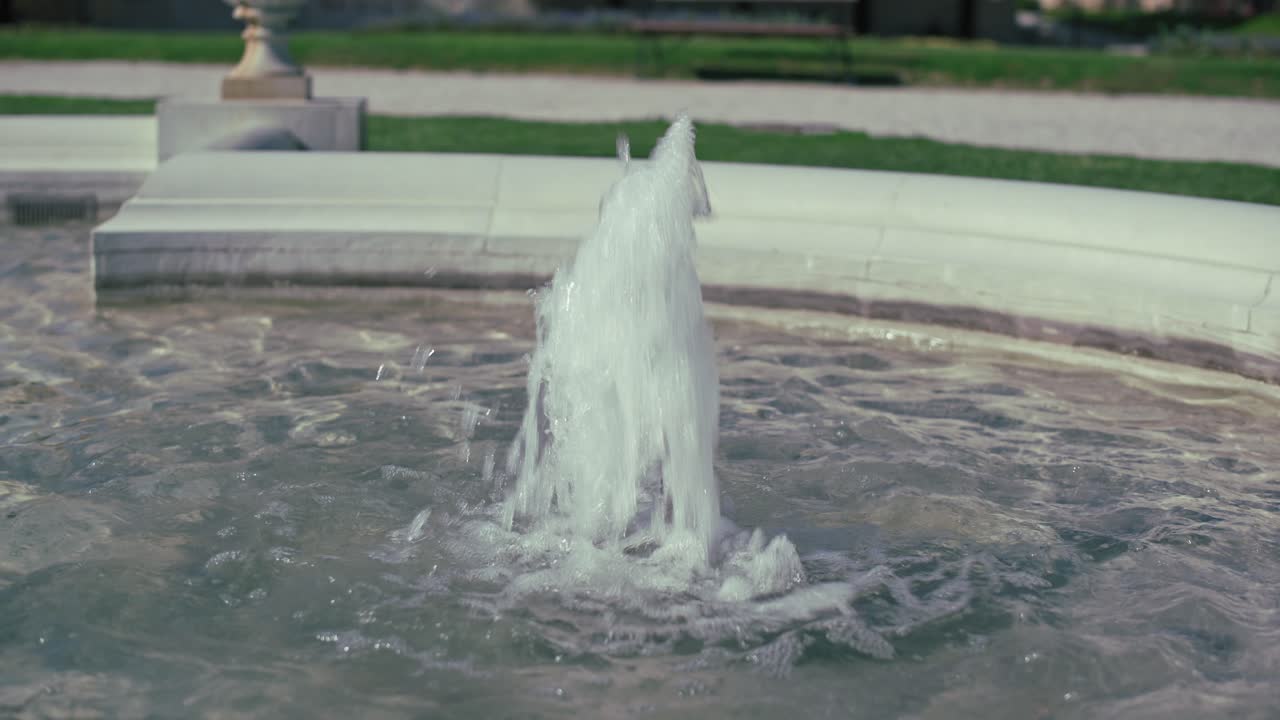 Close up of a fountain's water jet in King Tomislav Square, Zagreb, with a serene atmosphere