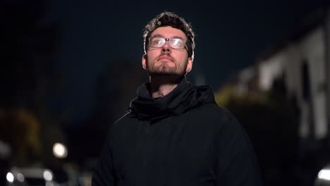 young man enveloped in cold german suburb night