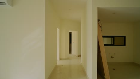 bright and clean interior passage with doorways in a modern residential property. pov walk through