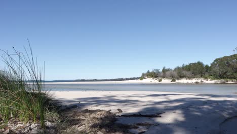 moona moona creek beach shore merging with jervis bay in australia, locked shot