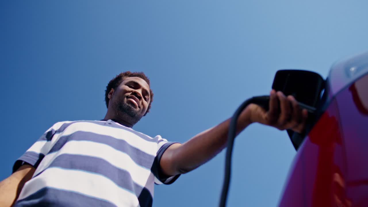 Man Charging an Electric Car