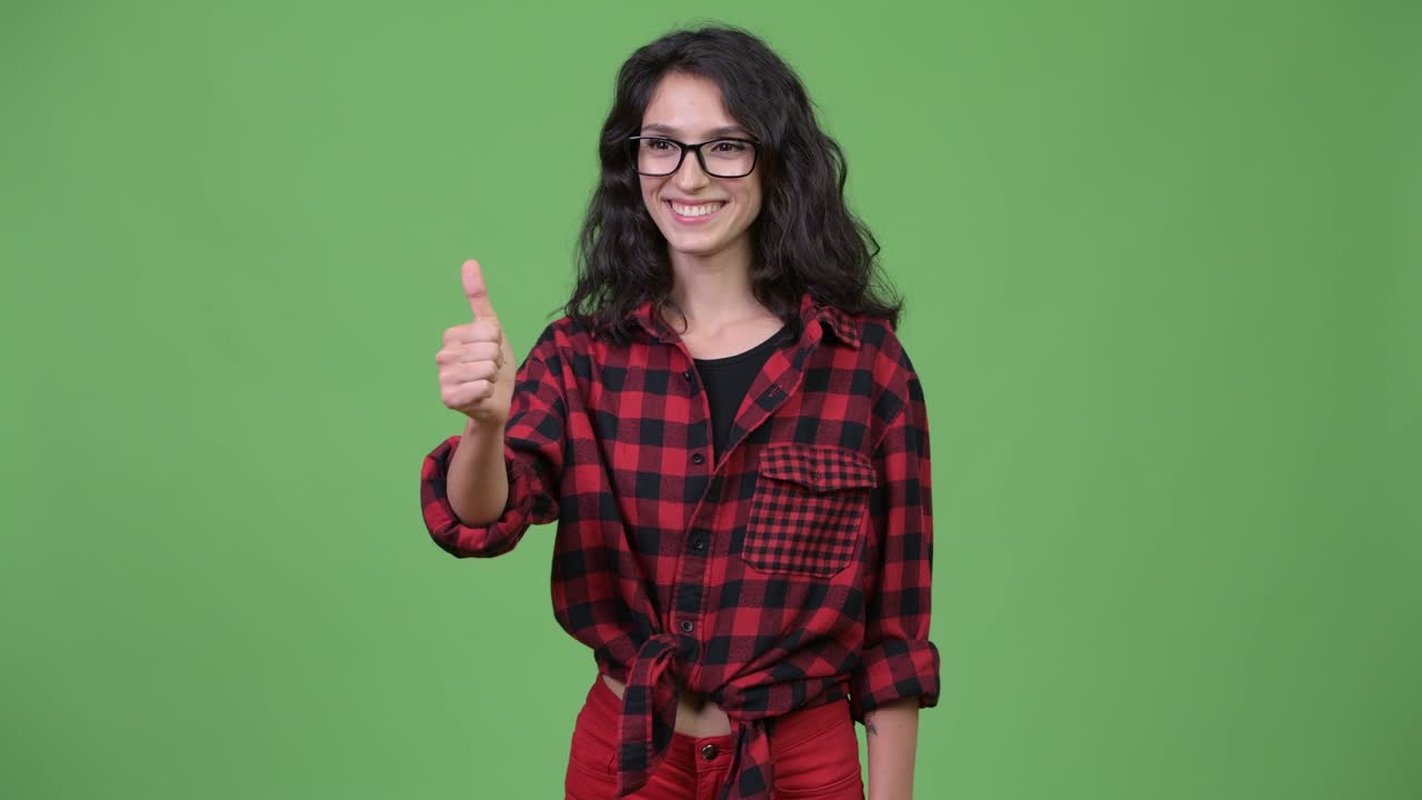 Young beautiful businesswoman giving thumbs up