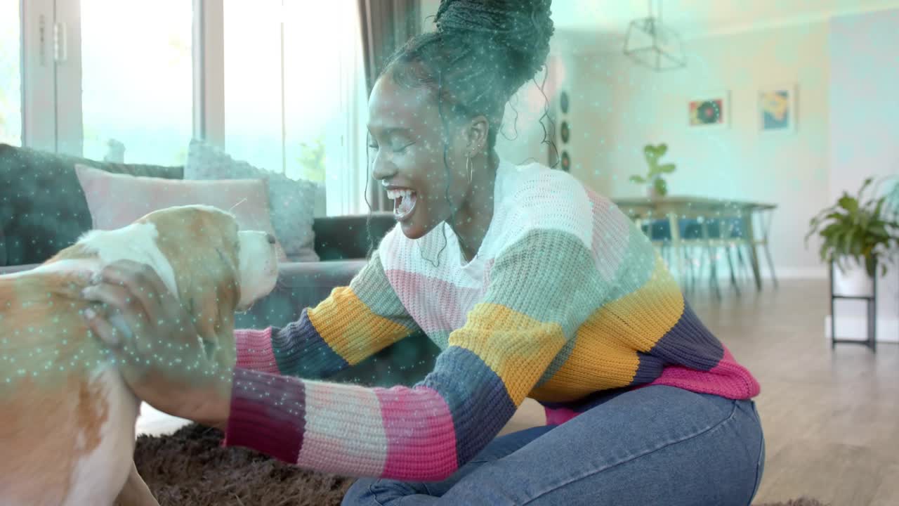 Woman reaching forward, lifting and petting dog on rug, pet care hearts floating, bonding