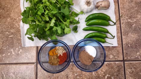 top down view of spices, herbs, peppers, garlic, onion, lemon - chana masala series