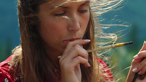 Inspired-woman-painter-thinking-nature-view.-Closeup-face-artist-working-outside