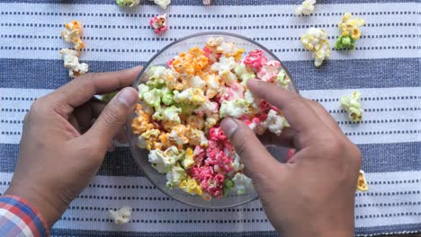 person holding a bowl of colorful popcorn