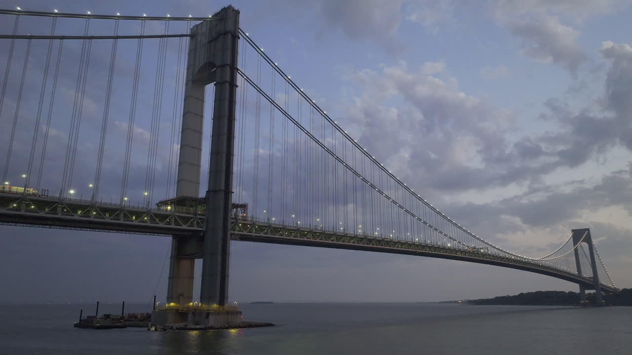 Aerial view of the Verrazzano-Narrows Bridge at night. Shot in Brooklyn looking towards Staten Island