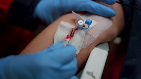 medical worker hands taking blood sample for coronavirus