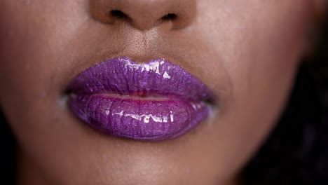 close-up of purple glitter lipstick on woman's lips