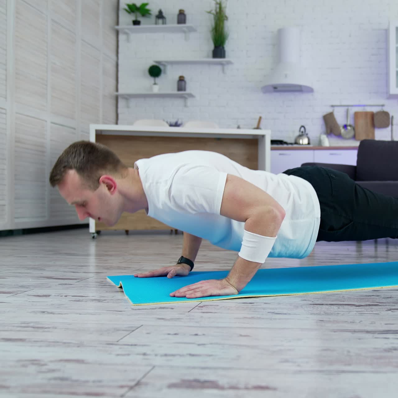 Home working out by healthy strong man. Man indoor doing exercise in quarantine