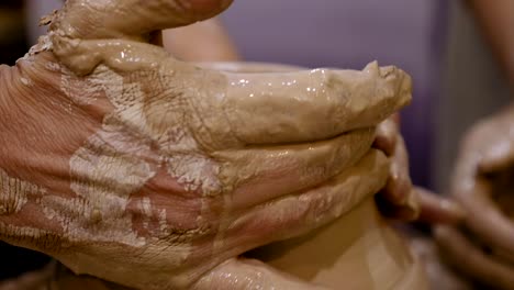 potter is making clay pot on the potter's wheel