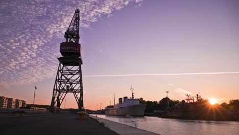 boats, crane and river at sunset