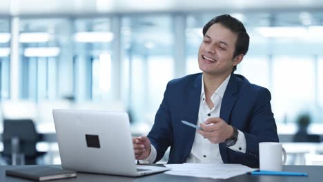 happy indian manager talking on video call