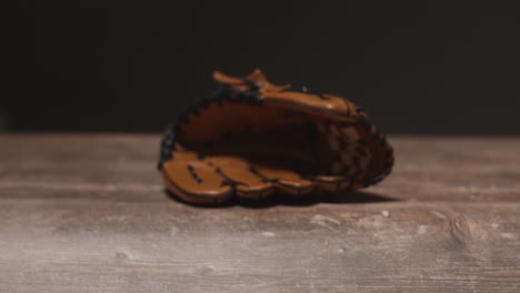 cerca de estudio de béisbol todavía la vida con receptores guante en el piso de madera 1