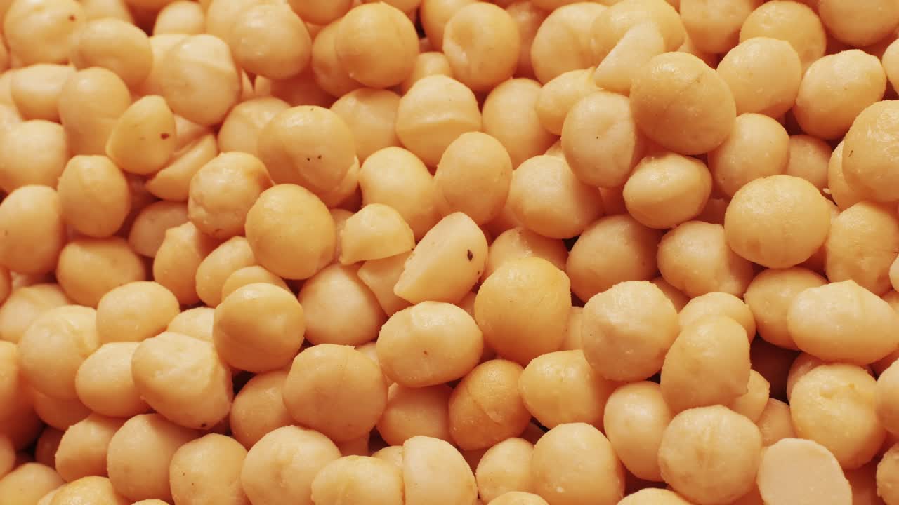 A highly detailed and closeup view showcasing lightcolored raw chickpeas beautifully spread across a surface