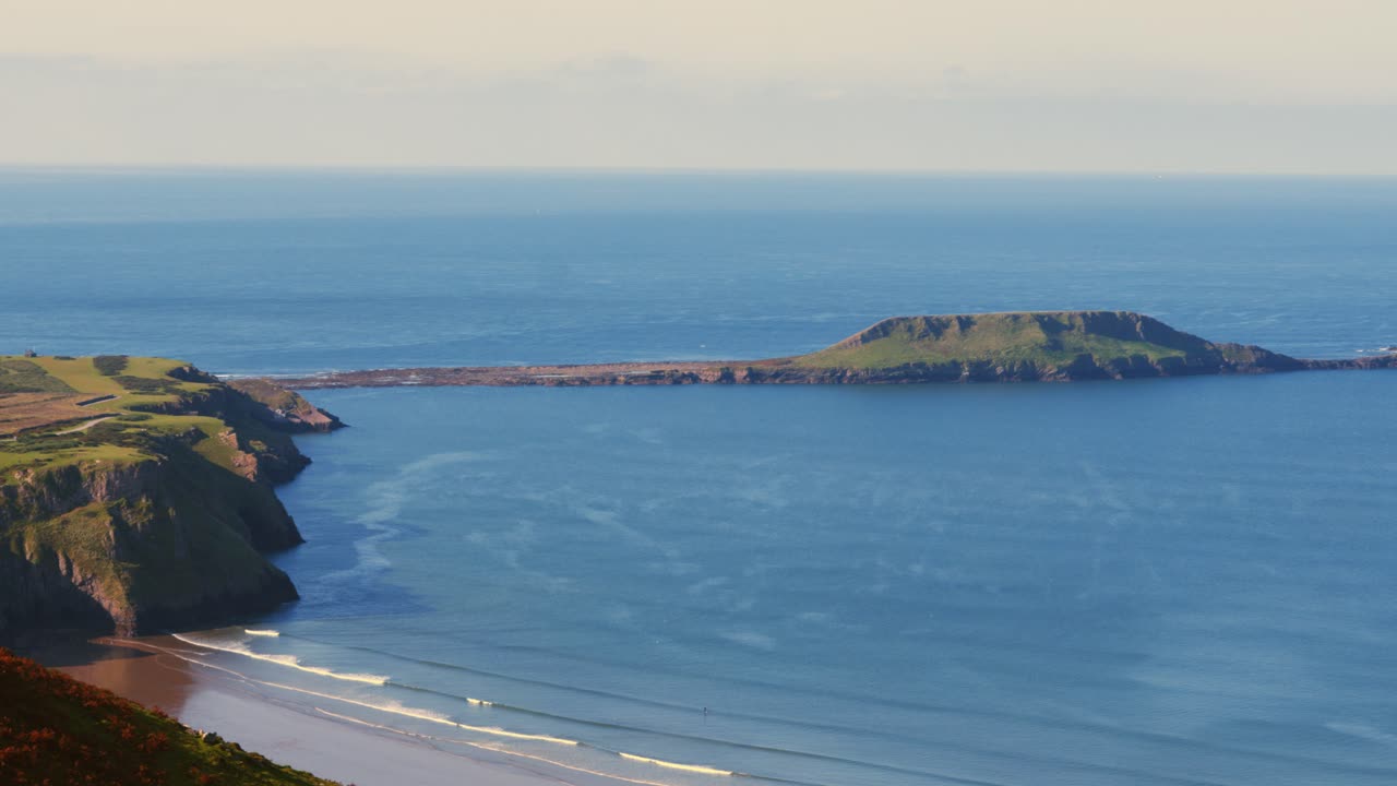 Amazing View of Rhossili Bay from Moorland Peak Revealing Worm's Head Landmark Causeway with Glistening Blue Sea Water. Tourism, Holiday Concept 4K