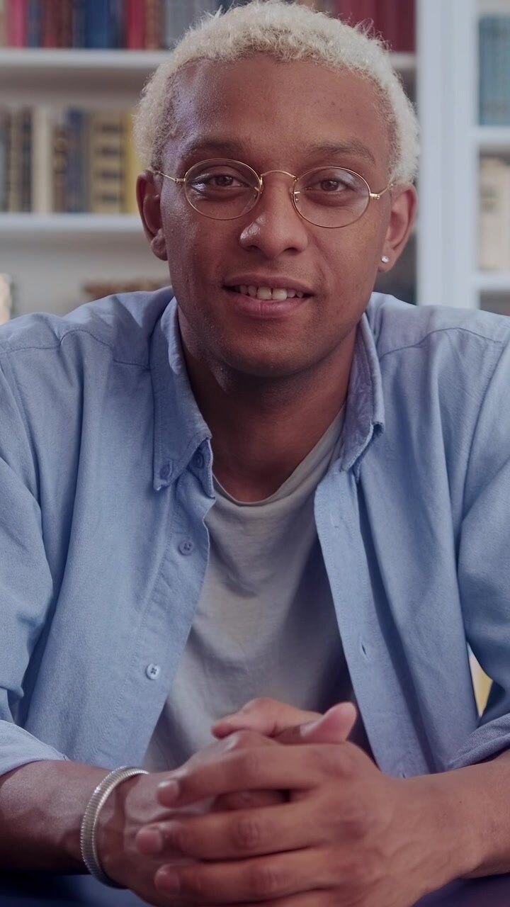 Friendly african american man smiles and talks to camera during interview or