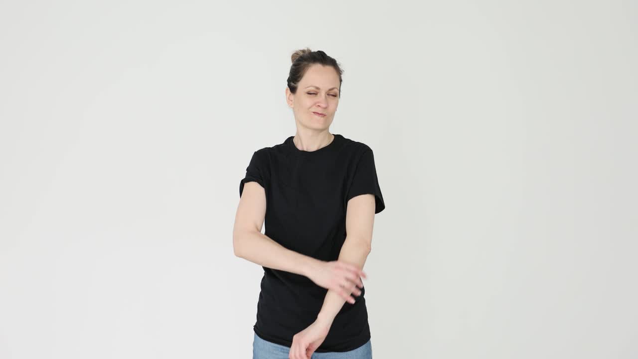 Woman in black t-shirt with hands on hips