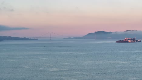 wide aerial view of alcatraz island and golden gate bridge, usa at sunrise