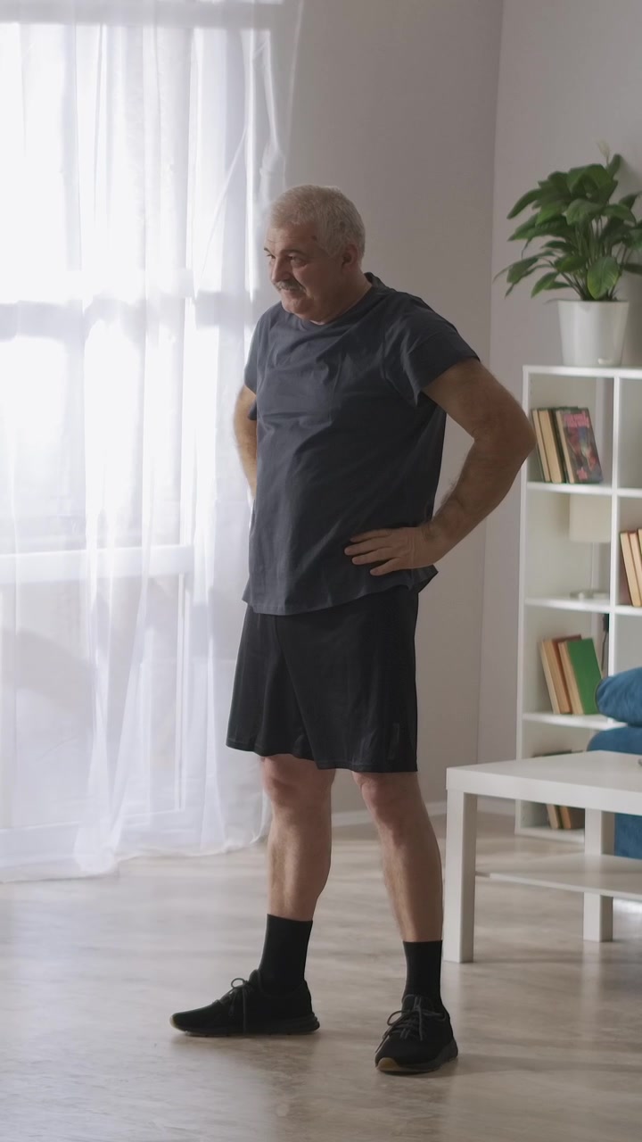 Senior Man Stretching Arms During Home Workout