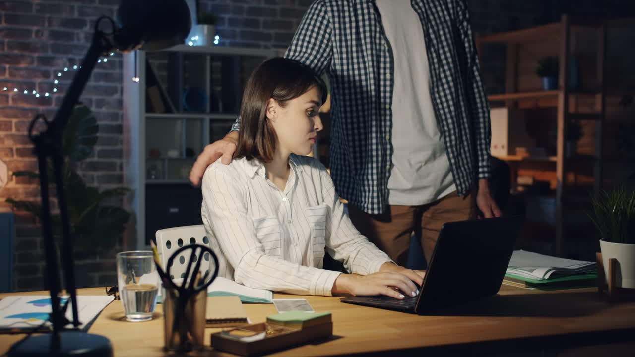 Woman and Man Working Late in Office