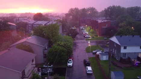 sunset storm over suburban neighborhood