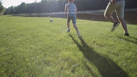 tracking video of father and son training soccer on holiday