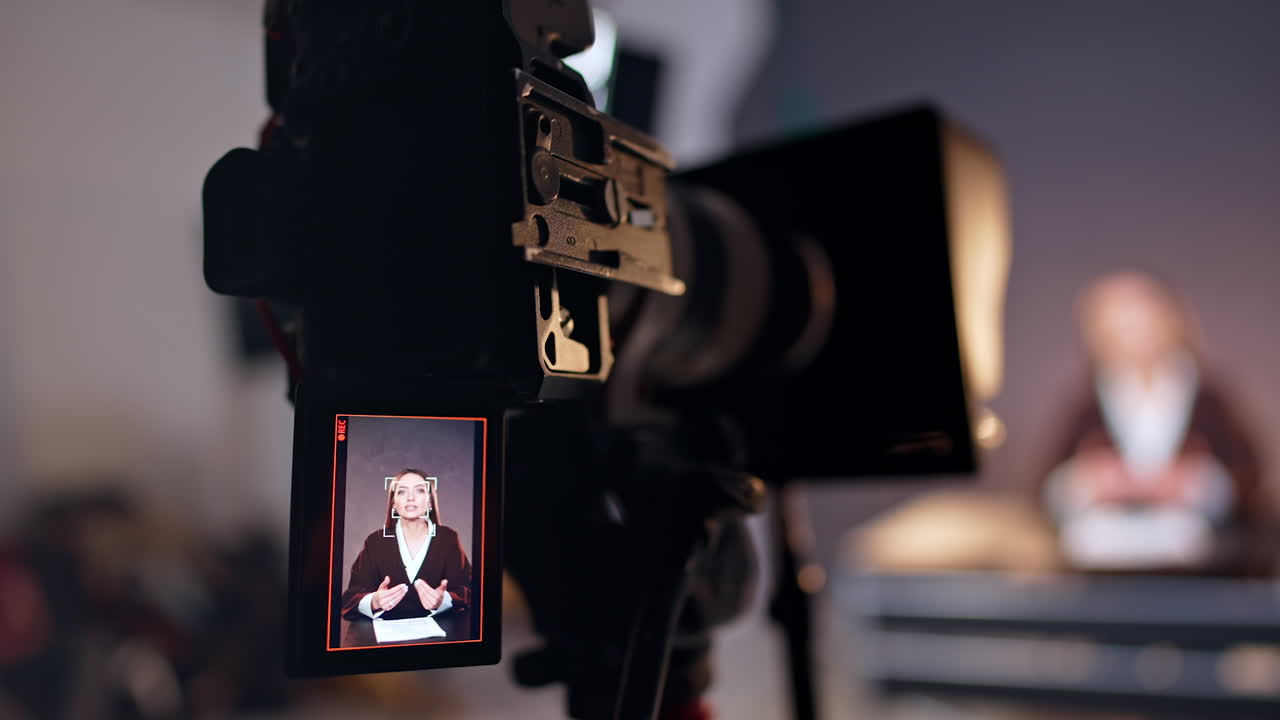 Caucasian woman recording a blog on the display of modern camera. Close up. Studio footage of a video