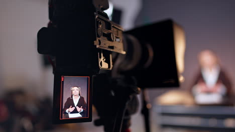 caucasian woman recording a blog on the display of modern camera. close up. studio footage of a video