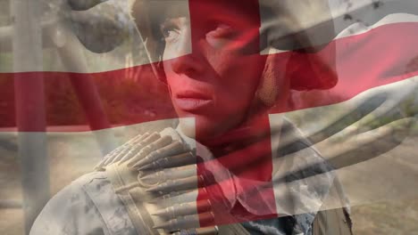 Animation-of-flag-of-england-over-biracial-male-soldier-with-weapon