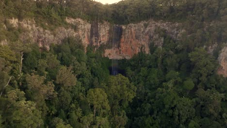 Purling-Brook-Falls-filmed-with-a-Drone-going-forward,-Australia