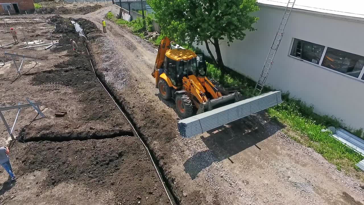 Tractor on construction site. Aerial view of tractor machine on construction site