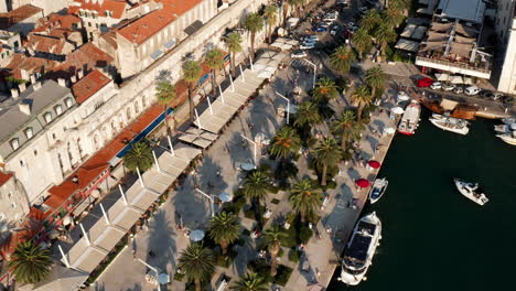 aerial view of the tourists walking along the riva promenade in split city, croatia