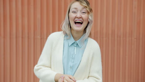 smiling woman laughing outdoors