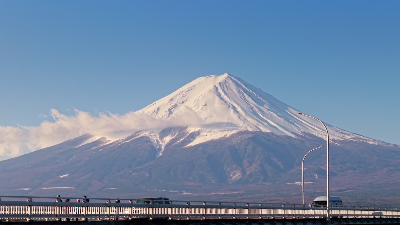 Aerial drone view of the Kawaguchiko-Ohashi bridge near the Fujikawaguchiko town in Japan with Mount Fuji on the background