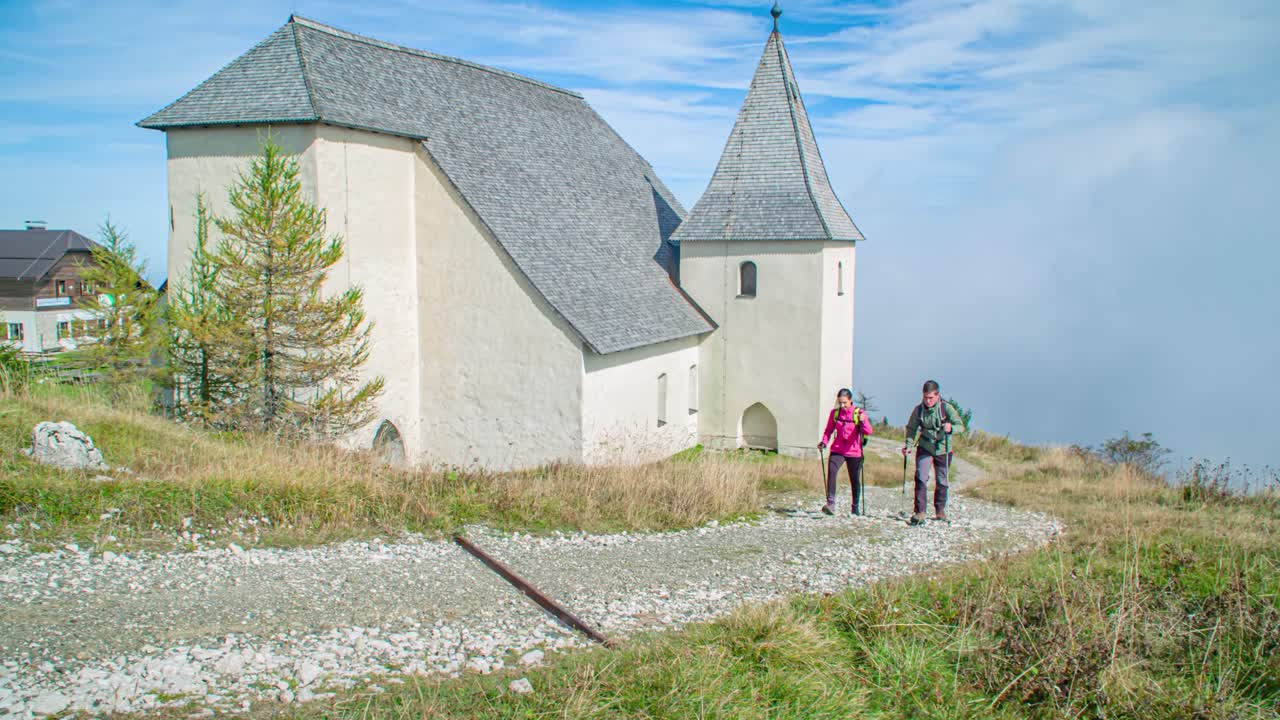 young couple hiking near Saint Ursula's Church, Urslja gora, Slovenia