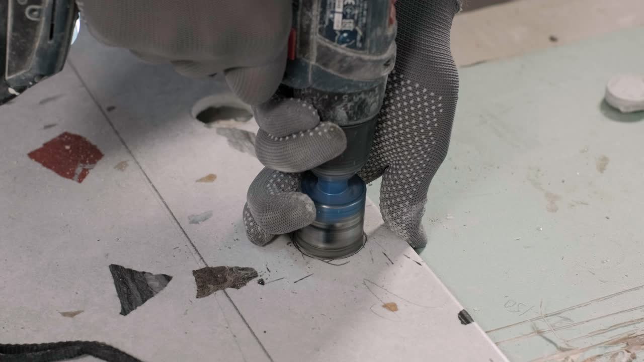 Construction, renovation, repair apartment. Installing ceramic floor tiles - measuring and cutting the pieces. Cuts tile. Tile cutting