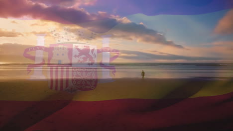 animación de la bandera de españa ondeando sobre una persona en la playa y un cielo azul nublado